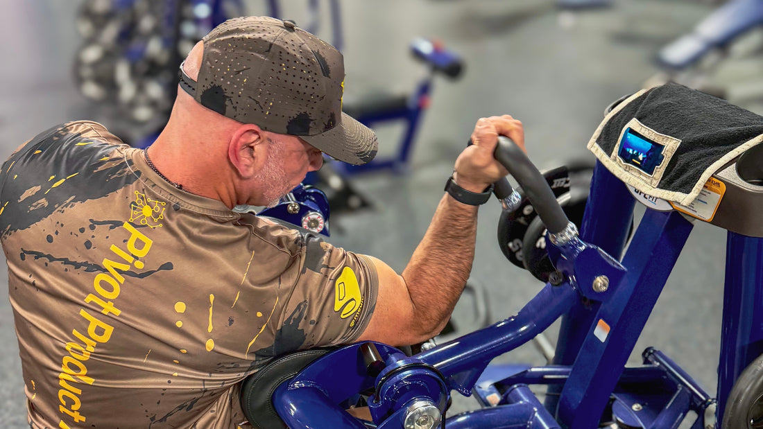 Man maximin gains and lifting proper form at gym watching training video on Media Towel 