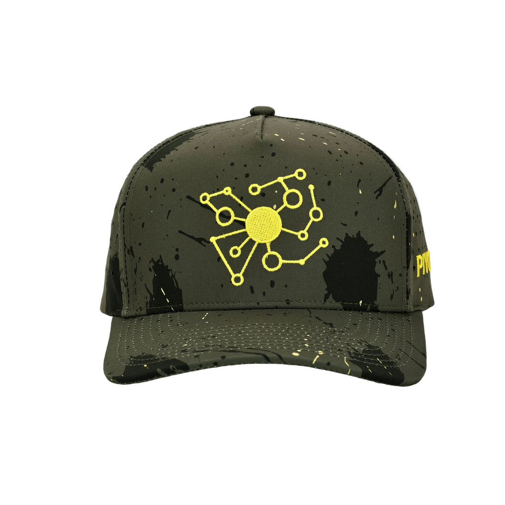 Front view of Pivot Product Designs hat in black with yellow embroidered logo, star perforations, and camo detailing