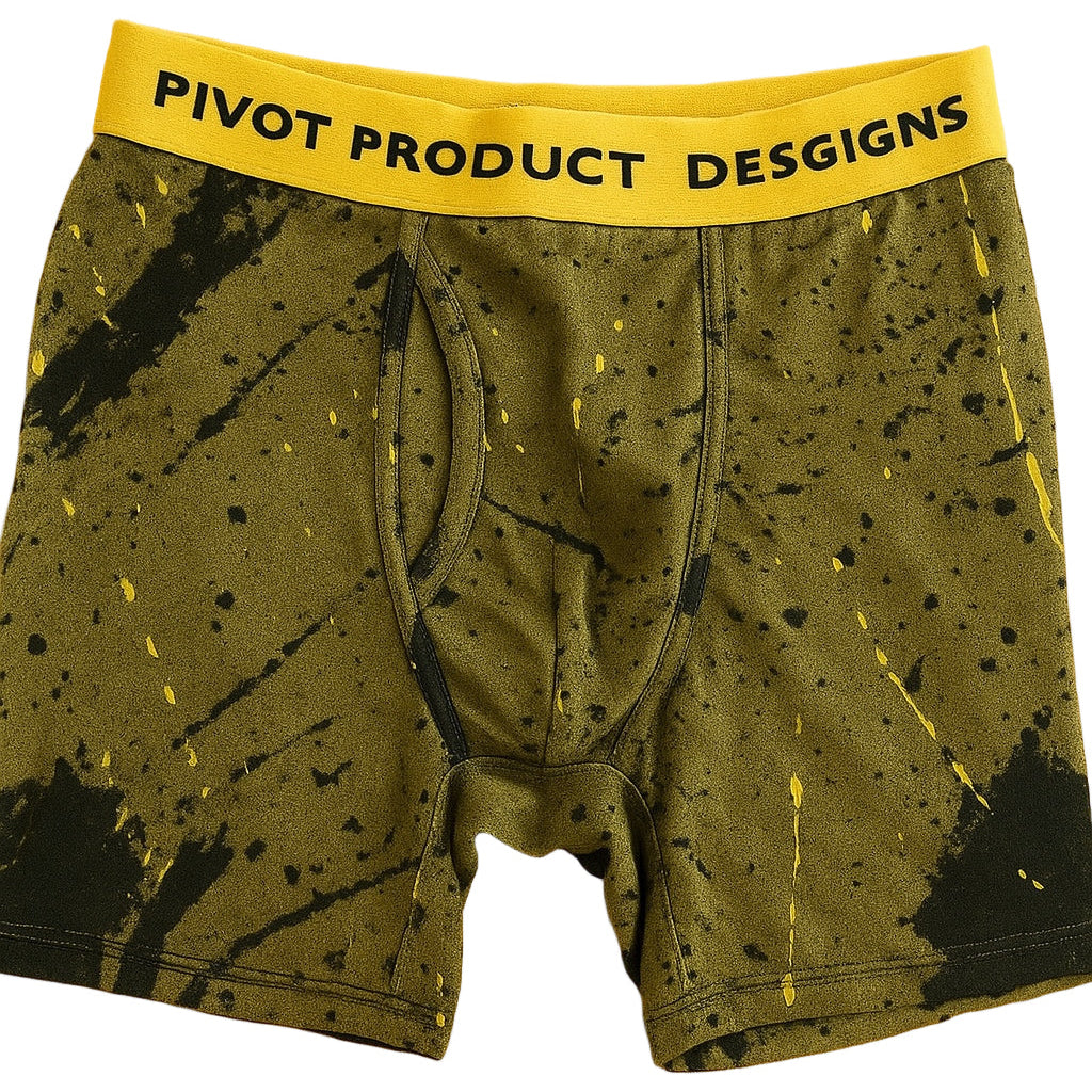 Green came boxer briefs with black splatter pattern and yellow waistband on a wooden surface