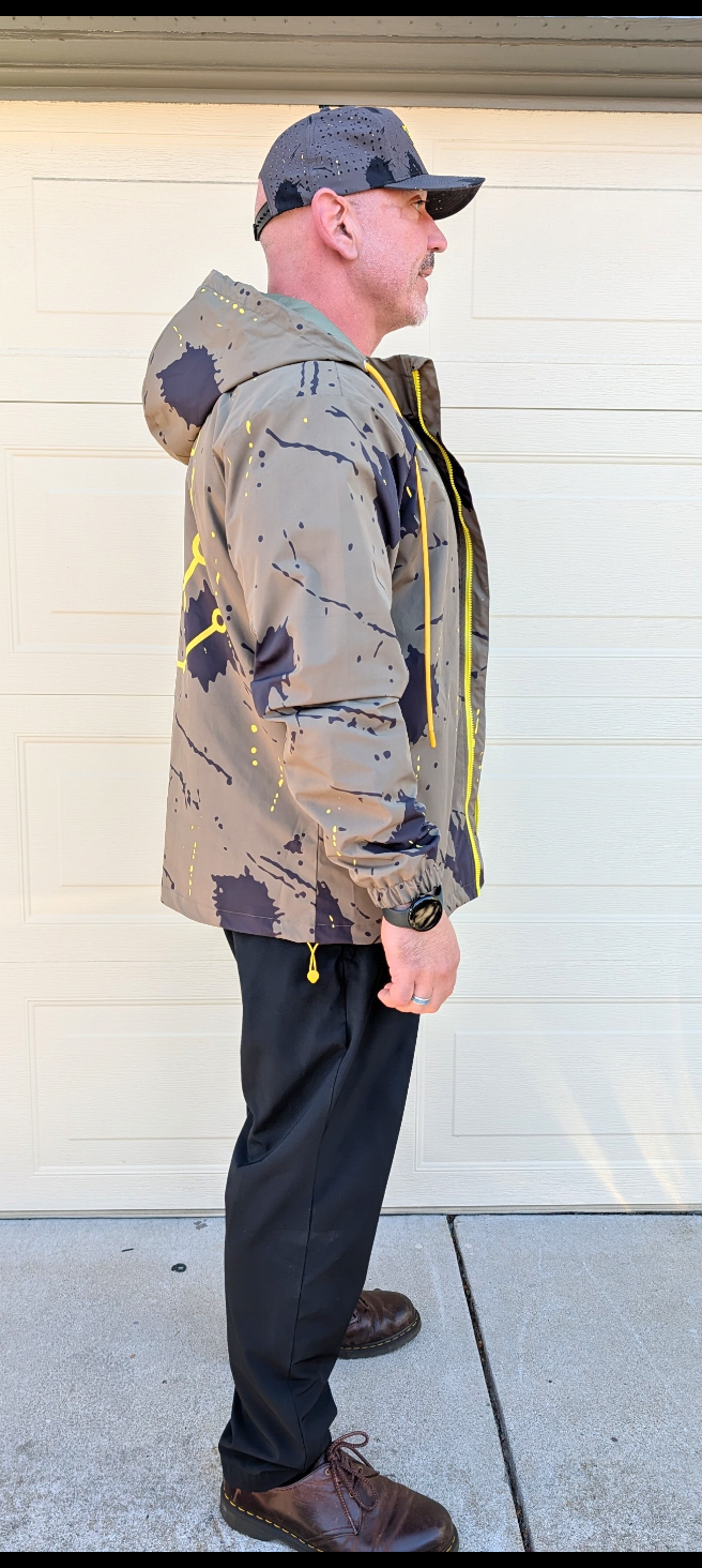 Action pose in the Pivot Storm Jacket Founder Edition showing the PIVOT PRODUCT DESIGNS embroidered wordmark on the side panel